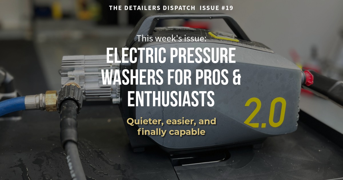 electric pressure washer on rolling cart with garage in background